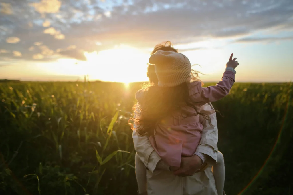 single mom and her daughter in farm land