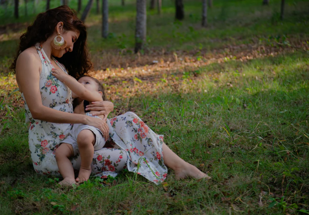 single mother playing wither baby in garden
